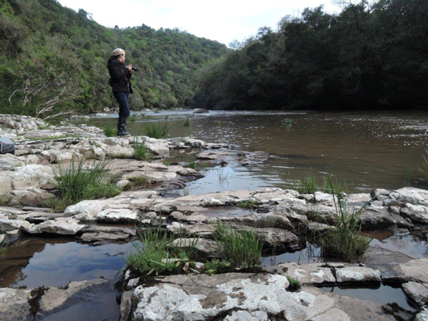 A woman standing next to a river